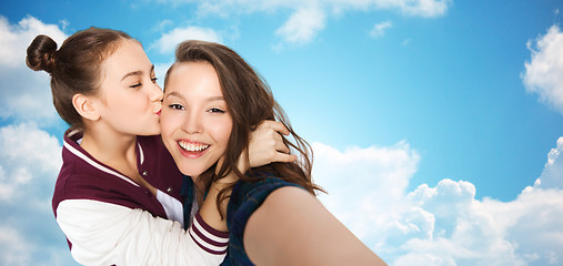 Image showing happy teenage girls taking selfie and kissing