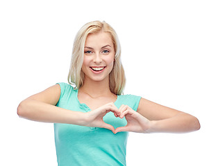 Image showing happy woman or teen girl showing heart shape sigh