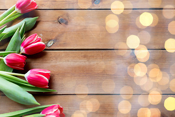 Image showing close up of tulip flowers on wooden table