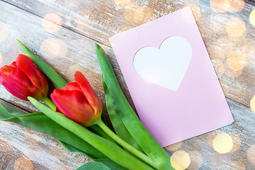 Image showing close up of tulips and greeting card with heart