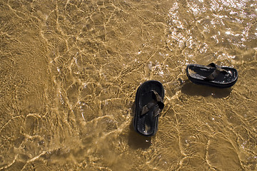 Image showing sandals in the water