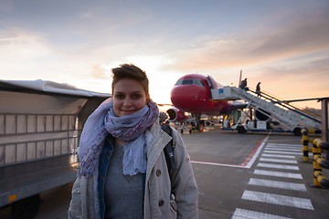 Image showing Young woman and airplane