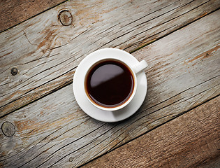 Image showing cup of coffee on wooden table