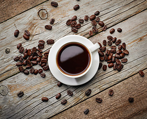 Image showing cup of coffee on wooden table