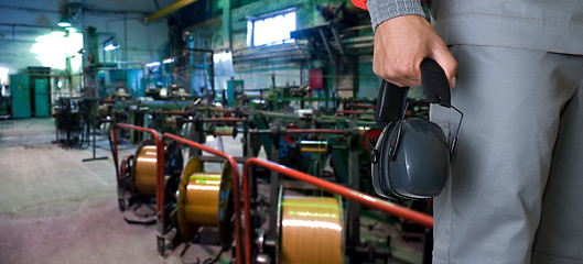 Image showing Worker with protective headphone