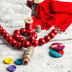 Image showing Beads,thread and red cloth