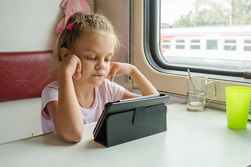 Image showing Girl looking at the tablet in the train