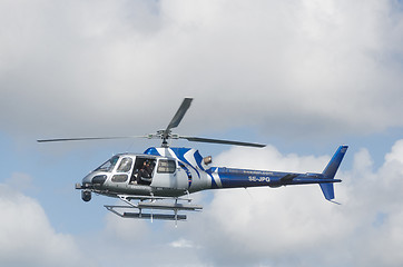 Image showing one blue and silver helicopter in the sky