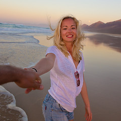 Image showing Romantic couple, holding hands, having fun on beach.