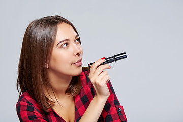 Image showing Closeup of smiling female holding pocket flashlight