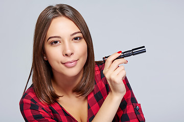 Image showing Closeup of smiling female holding pocket flashlight