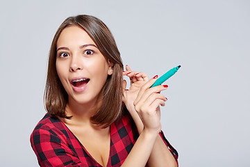 Image showing Surprised woman with a pen