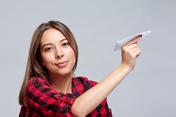 Image showing Dreamy female holding white paper plane