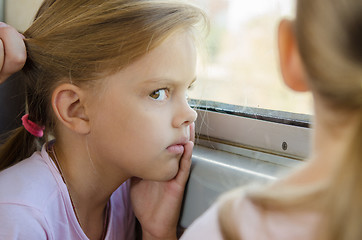 Image showing The girl glared at the other girl in electric windows