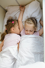 Image showing Sisters sleep on the bottom shelf in a train