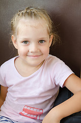 Image showing Happy girl sitting on a chair in an electric train, close-up