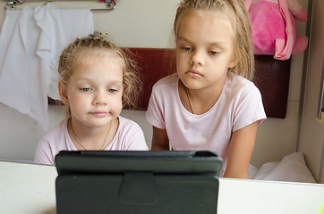 Image showing Sisters looking at tablet in the train