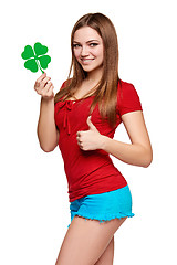 Image showing Happy teenager holding shamrock leaf