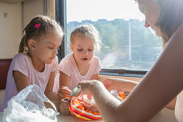 Image showing My mother unpacks the food for hungry children in second-class train carriage