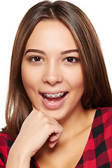 Image showing Teen female smiling with braces on her teeth