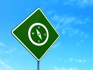 Image showing Travel concept: Compass on road sign background