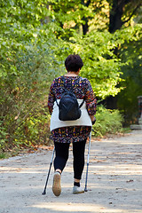 Image showing Middle-aged woman walking in park