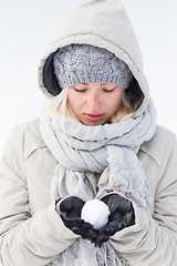 Image showing Girl  holding snowball in cold winter time.