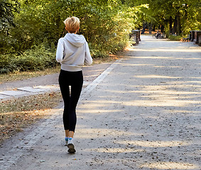 Image showing Anorexic woman running in park