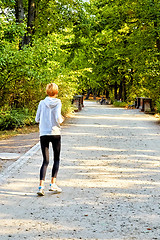Image showing Anorexic woman running in park