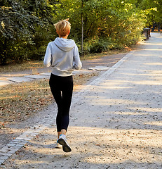 Image showing Anorexic woman running in park