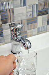 Image showing Filling glass of water from  kitchen faucet