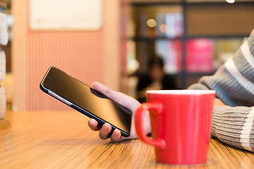 Image showing Woman hand holding mobile phone