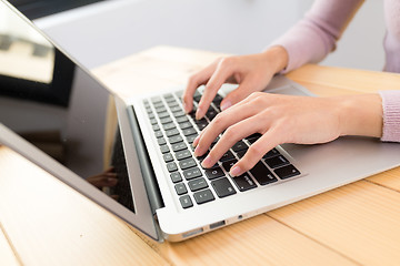 Image showing Woman typing on laptop computer