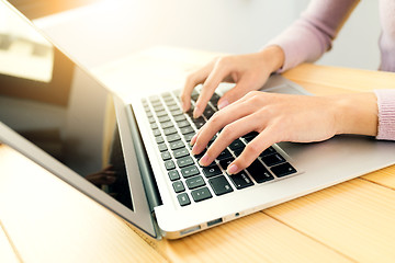 Image showing Woman typing on notebook computer