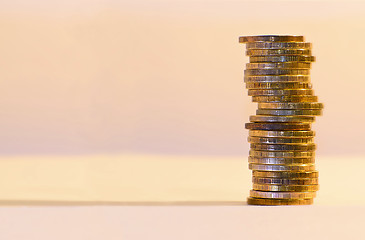 Image showing Stack of coins close-up on a gold background