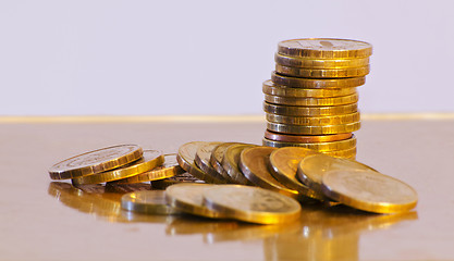 Image showing Stack of coins close-up on a gold background