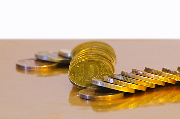 Image showing Stack of coins close-up on a gold background