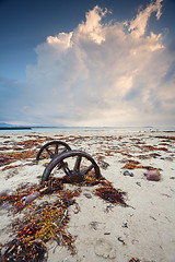 Image showing Rusty wheels in the sand