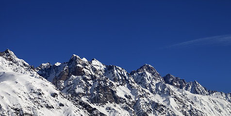 Image showing Panoramic view on snowy rocks and blue clear sky at nice sun day