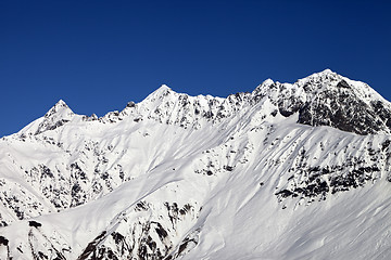 Image showing Snowy mountains and blue clear sky at sun day