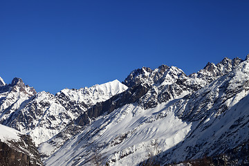 Image showing View on snowy rocks and blue clear sky at nice sun day