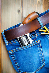 Image showing old silver revolver and vintage blue jeans