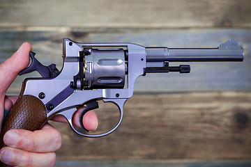 Image showing human hand with revolver