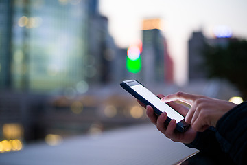 Image showing Woman using her Mobile Phone in the street