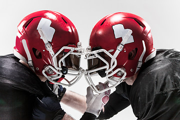 Image showing The two american football players fighting on white background