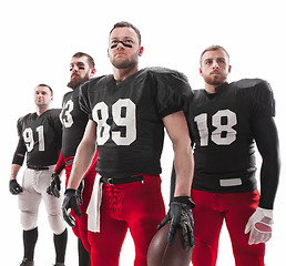 Image showing The four american football players posing with ball on white background