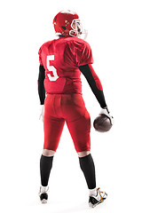 Image showing American football player posing with ball on white background