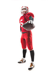 Image showing American football player posing with ball on white background