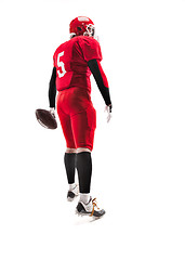 Image showing American football player posing with ball on white background