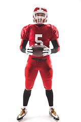 Image showing American football player posing with ball on white background